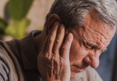 Stressed, unhappy man with severe earache mobile image